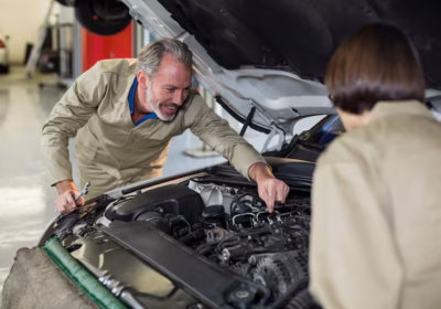 mechanic pointing out car parts to a customer